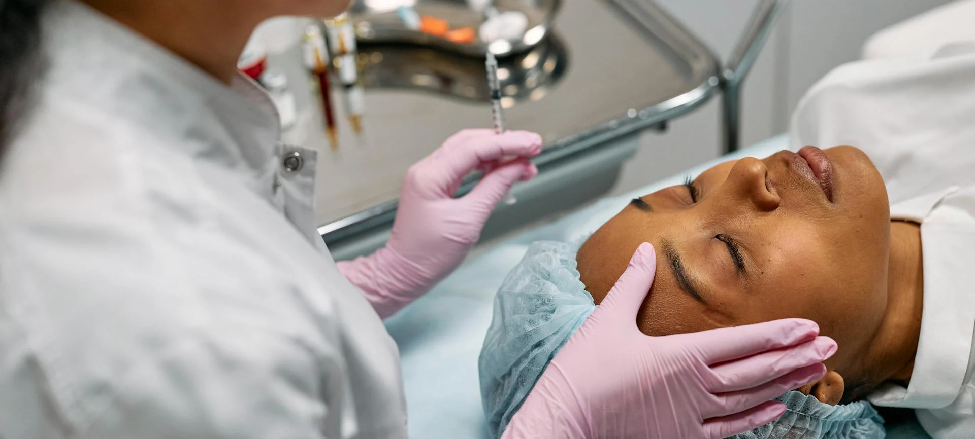 Practitioner assessing forehead muscle movement before neuromodulator treatment