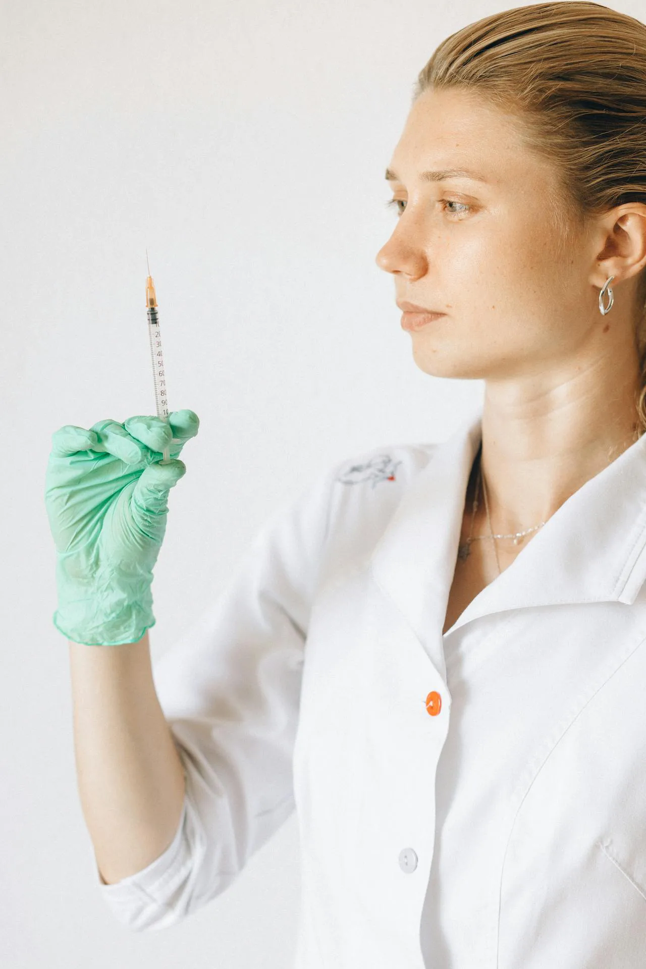 Injector preparing dermal filler syringe in a modern Okotoks medical aesthetics clinic